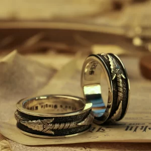 Introducing Silveringdom’s matching rings, a perfect blend of elegance and symbolism. Crafted from dark silver, these rings feature intricate designs that highlight their exquisite craftsmanship. One ring showcases a unique arrow motif, pointing towards the center, symbolizing direction and unity. The dark silver finish adds a touch of sophistication, making these rings a standout piece in any collection. Ideal for couples or close friends, these matching rings from Silveringdom are more than just jewelry; they are a statement of connection and shared journey. Whether for a special occasion or everyday wear, these rings are designed to be cherished and admired.