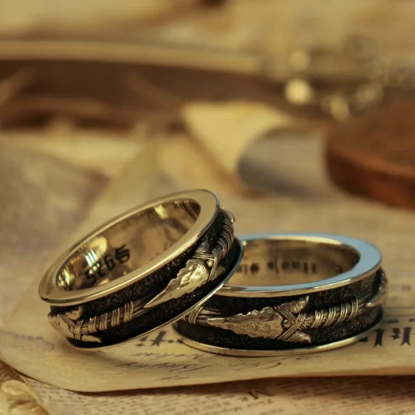 Introducing Silveringdom’s wedding bands, a symbol of eternal love and commitment. These rings, crafted from dark silver, feature intricate designs that exude elegance and sophistication. Perfect for couples, these matching rings represent a timeless bond, making them an ideal choice for weddings or anniversaries. The detailed craftsmanship ensures that each ring is unique, reflecting the individuality of your relationship. Celebrate your special moments with Silveringdom’s wedding bands, designed to be cherished forever.