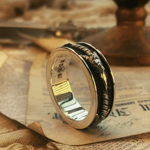 Introducing Silveringdom’s elegant ring, a stunning piece crafted from dark silver. This ring features a unique black inlay with intricate patterns, adding a touch of sophistication and mystery. The textured edges enhance its distinctive design, making it a perfect choice for those who appreciate fine craftsmanship and detailed artistry. Ideal for both special occasions and everyday wear, this ring from Silveringdom is more than just an accessory; it’s a statement of style and elegance. Embrace the beauty and uniqueness of this exquisite ring, and let it be a symbol of your refined taste and individuality.