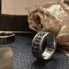 In the enchanting realm of Silveringdom, behold a pair of matching rings that epitomize elegance and unity. The prominent ring, crafted from dark silver, features an intricate iris design, symbolizing wisdom and valor. Its companion, equally majestic, shares this noble motif, reminiscent of a knight’s steadfast resolve. These rings are not mere adornments but emblems of commitment, forged with precision and care. Their subtle sheen catches the light, reflecting the timeless vows they represent. Together, they stand as a testament to enduring love and loyalty, perfect for those who seek a blend of tradition and modernity in their cherished jewelry.