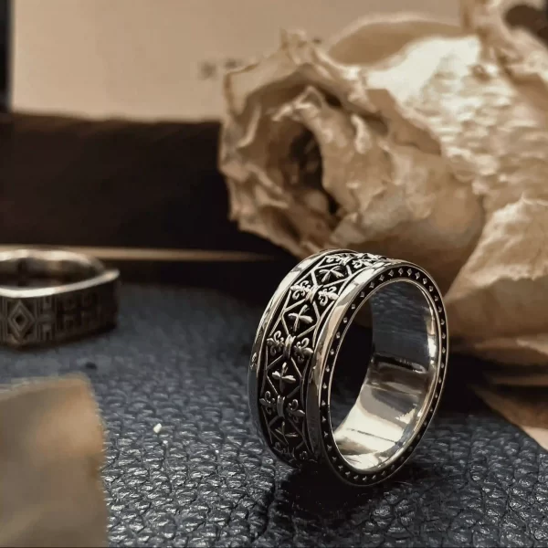 In the enchanting realm of Silveringdom, behold a pair of matching rings that epitomize elegance and unity. The prominent ring, crafted from dark silver, features an intricate iris design, symbolizing wisdom and valor. Its companion, equally majestic, shares this noble motif, reminiscent of a knight’s steadfast resolve. These rings are not mere adornments but emblems of commitment, forged with precision and care. Their subtle sheen catches the light, reflecting the timeless vows they represent. Together, they stand as a testament to enduring love and loyalty, perfect for those who seek a blend of tradition and modernity in their cherished jewelry.
