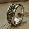 In the heart of Silveringdom, a pair of matching rings gleam with an ethereal glow. Each ring, crafted from dark silver, features intricate designs that resemble the delicate petals of an iris in full bloom. The craftsmanship is reminiscent of a bygone era, evoking the image of a noble knight who might have worn such a ring as a symbol of loyalty and honor. The rings’ interlocking patterns suggest a deep connection, perhaps a vow or a promise, held within their circular embrace. These exquisite pieces are not just jewelry but a tangible link to the storied past and romantic ideals of Silveringdom, where every detail tells a tale of chivalry and timeless beauty.