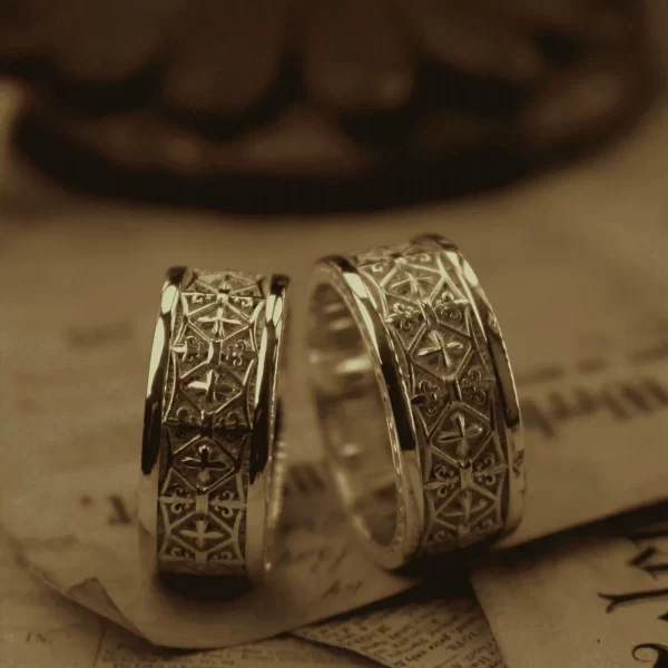 Introducing the exquisite Silveringdom Matching Rings, crafted from light silver and designed to symbolize eternal love and unity. These rings feature intricate engravings reminiscent of a knight’s armor, evoking a sense of medieval elegance and strength. The delicate iris motifs add a touch of natural beauty and grace, making these rings perfect for couples who appreciate both history and nature. Each ring is a testament to fine craftsmanship, blending robustness with refined details. Whether for an engagement, wedding, or anniversary, the Silveringdom Matching Rings are a timeless choice that will be cherished for generations. Embrace the noble spirit of the past with these stunning pieces of jewelry.