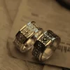 In the enchanting realm of Silveringdom, these matching rings stand as symbols of unity and elegance. The first ring, crafted in light silver, showcases intricate patterns reminiscent of a noble knight’s armor, reflecting a soft, ethereal glow. Its counterpart, in dark silver, mirrors the same exquisite design, absorbing light to create a striking contrast. Both rings feature a central iris motif, symbolizing vigilance and protection. Together, they tell a story of timeless bonds and shared journeys, perfect for those who seek a blend of tradition and modernity in their jewelry. These rings are not just accessories but heirlooms, capturing the essence of Silveringdom’s craftsmanship and artistry.