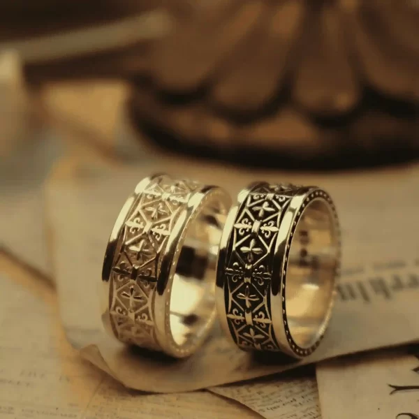In the enchanting realm of Silveringdom, these matching rings tell a tale of unity and elegance. The first ring, in light silver, gleams like a knight’s armor under the morning sun, adorned with delicate scrollwork that mirrors the intricate beauty of an iris in bloom. Its counterpart, in dark silver, exudes a mysterious allure, reminiscent of a knight’s steadfast resolve in twilight. Together, these rings symbolize a bond forged in both light and shadow, perfect for those who cherish a timeless connection. Whether worn as a testament to love or a pledge of loyalty, these rings from Silveringdom capture the essence of chivalry and romance.