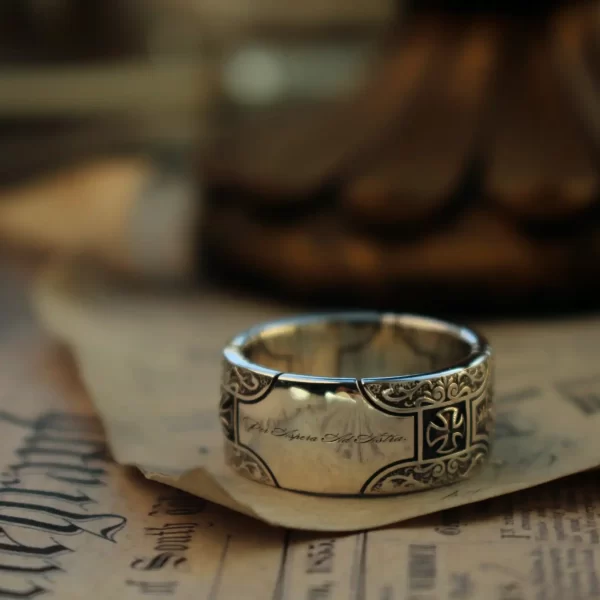 Introducing the Silveringdom Matching Rings, a stunning pair crafted from dark silver. Each ring features an intricate cross design, symbolizing unity and timeless elegance. The rings are meticulously detailed, with the word ‘Silveringdom’ etched into their surface, highlighting their unique brand identity. The dark silver hue gives these rings an antique and sophisticated look, perfect for those who appreciate classic yet contemporary jewelry. Whether worn as a symbol of commitment or as a stylish accessory, these matching rings from Silveringdom are sure to make a statement. The cross motif adds a touch of historical and spiritual significance, making these rings a meaningful addition to any jewelry collection.