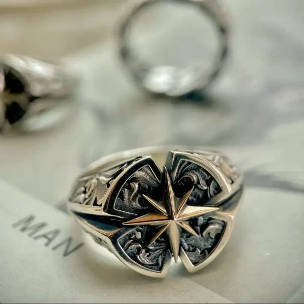 Introducing the exquisite Silveringdom collection, featuring matching rings that epitomize elegance and craftsmanship. The centerpiece of this collection is the Polaris design, where the star motif shines brilliantly amidst intricate detailing. Crafted in dark silver, these rings offer a luxurious yet understated aesthetic. The Polaris symbol stands out in high relief against the darkened background, creating a striking contrast that highlights the precision of the design. Each ring’s surface is adorned with patterns reminiscent of rose petals, adding to their overall allure. This collection exudes sophistication and is perfect for those seeking jewelry that makes a statement while maintaining an air of mystique and timeless style.