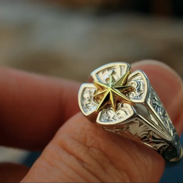 The Silveringdom collection presents matching rings that embody elegance and versatility. This handcrafted piece features a Polaris motif, symbolizing guidance and direction, intricately designed in light silver. The androgynous style ensures it appeals to all, with a delicate rose pattern adding a touch of organic beauty. Each ring can be customized to reflect personal tastes, making it a unique symbol of connection. The detailed engravings and polished finish highlight the craftsmanship, making it a standout addition to any jewelry collection. Perfect for those who appreciate both style and meaning in their accessories.
