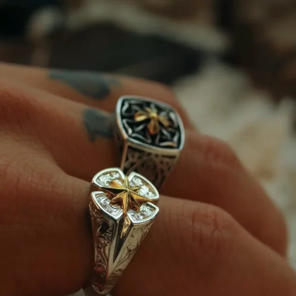 Introducing the Silveringdom collection’s exquisite matching rings, featuring a stunning Polaris motif. These rings are handcrafted with meticulous attention to detail, showcasing intricate patterns etched into the light silver metal. At the center of each ring is a delicate rose design, with one ring featuring a gilded rose for added elegance. The overall androgynous aesthetic makes these rings perfect for anyone, regardless of gender. Additionally, these rings offer the option to customize, allowing you to add a personal touch to your unique piece. Whether for a special occasion or everyday wear, these rings are a testament to fine craftsmanship and timeless design.